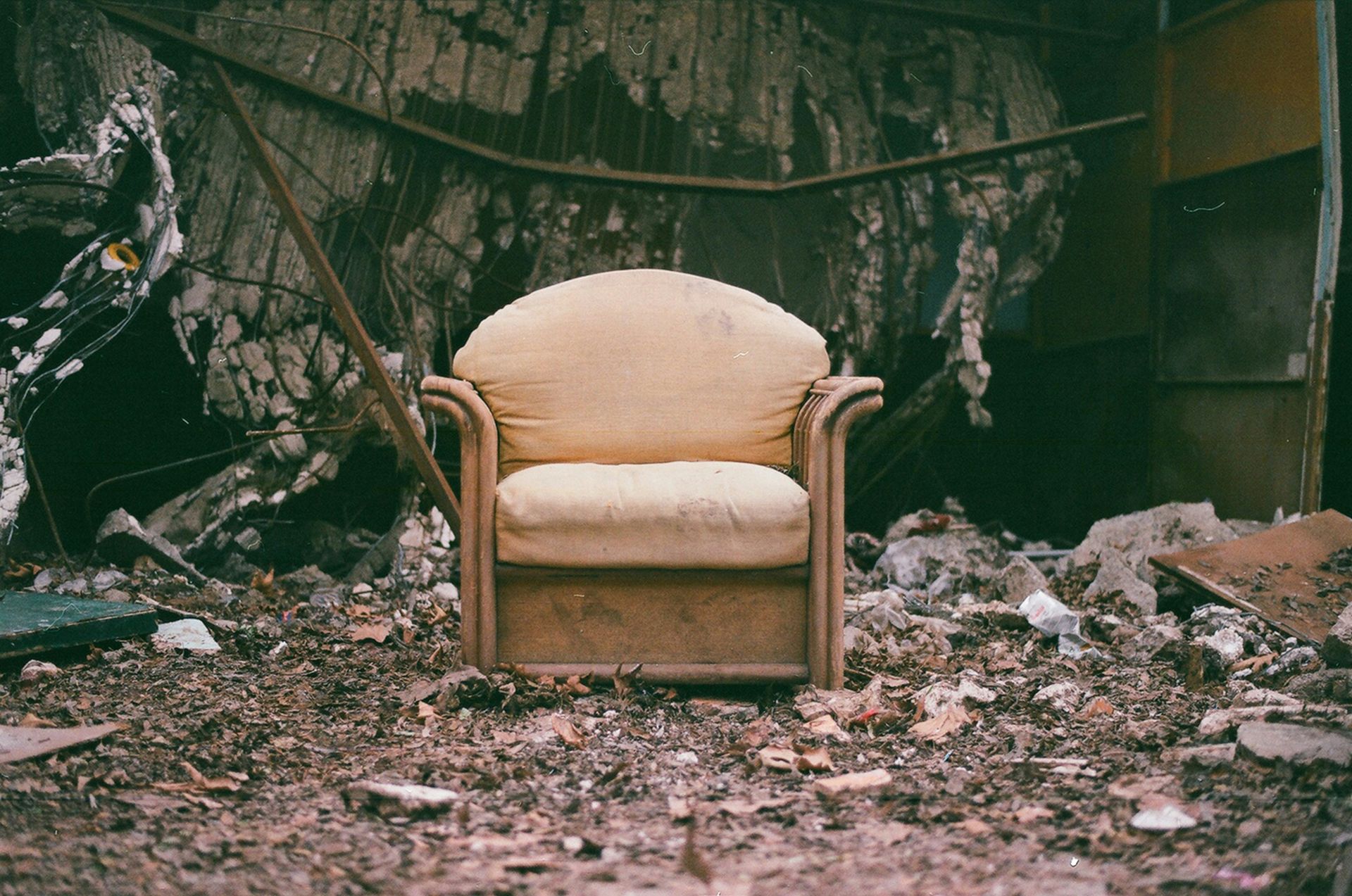 brown wooden armchair on brown soil